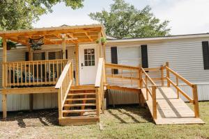 a screened in porch on a house with a large deck at The Hidden Creek Hideaway in Huntsville