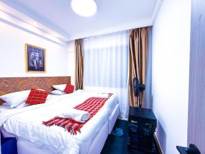 a bedroom with a bed with red and white pillows at SPOTLESS HOSTEL, WESTLANDs Orc in Nairobi +24 photos