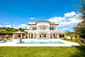 a large house with a swimming pool in the yard at Luxury Panorama Vila with amazing Seaview in Gondolici 7 km from Rabac in Labin
