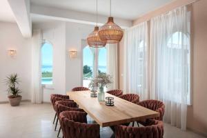 a dining room with a wooden table and chairs at Luxury Panorama Vila with amazing Seaview in Gondolici 7 km from Rabac in Labin