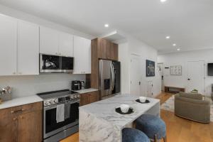 a kitchen with white cabinets and a stove top oven at Modern House in Seattle in Seattle