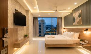 a bedroom with a bed and a large window at Harvey's Suites in Gachibowli