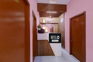 a hotel hallway with a hotel sign on the counter at Hotel O Parthasarathyswamy Temple Formerly RKH Inn in Chennai