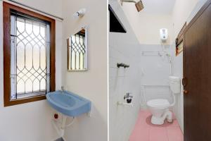 a bathroom with a blue sink and a toilet at Hotel O Parthasarathyswamy Temple Formerly RKH Inn in Chennai