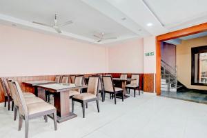a dining room with tables and chairs at Collection O Haridwar Railway Station Formerly Le Central in Haridwār