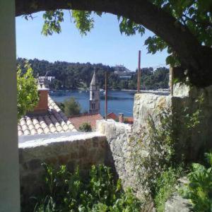 a stone wall with a view of a river at Apartments Ana Old Town in Cavtat