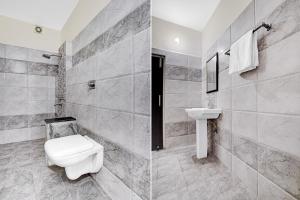 a bathroom with a toilet and a sink at Super Hotel O by OYO Clock Tower Ludhiana Formerly Greatwall in Ludhiana
