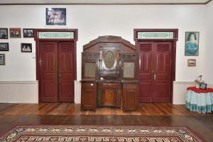 a room with two red doors and a rug at Maya Sari Cottage Pandai Sikek in Kotabaru