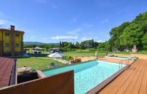 a large swimming pool on a wooden deck at Beautiful Home In Arezzo in Arezzo +14 photos