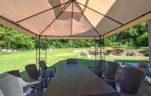 a table and chairs under a large tent at Beautiful Home In Arezzo in Arezzo