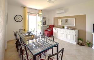 a dining room with a table and chairs and a clock at Beautiful Home In Arezzo in Arezzo