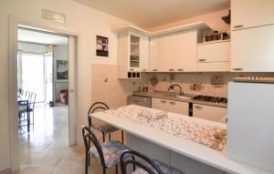 a kitchen with white cabinets and a counter top at Beautiful Home In Arezzo in Arezzo