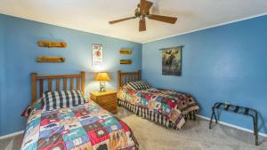 a bedroom with two beds and a ceiling fan at Arena by AvantStay in North Creek +39 photos