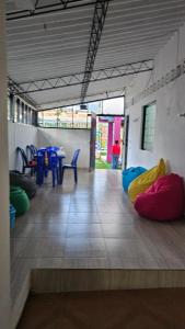 a room with colorful bean bags on the floor at El Cacique Villeta Hostal in Villeta