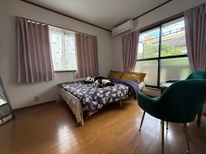 a bedroom with a bed with a stuffed animal on it at Hana88 in Otsu
