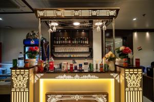 a bar in a restaurant with a fireplace at Hotel Gharana Tree in Gaya