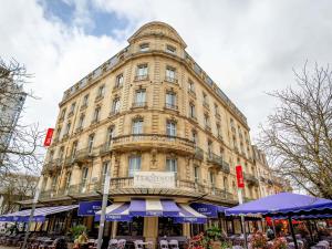 a large building with a balcony on top of it at ibis Bordeaux Centre Gare Saint Jean Euratlantique in Bordeaux