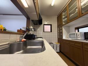 a kitchen with a sink and a microwave at Hana88 in Otsu