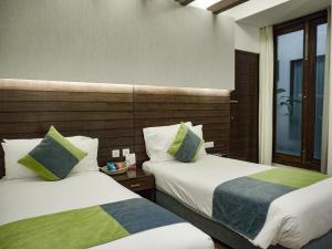 a hotel room with two beds and a window at Hotel Icon in Chandīgarh