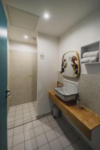 a bathroom with a sink and a mirror at HÔTEL LE TERRE SAINTE in Saint-Pierre +38 photos