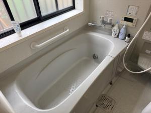a white bath tub in a bathroom with a window at Hana88 in Otsu +18 photos