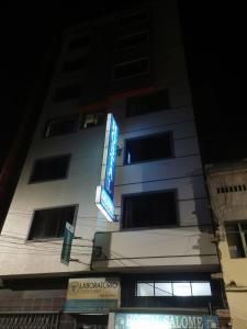 a tall building with a sign on the side of it at Hostal Salome in Cochabamba