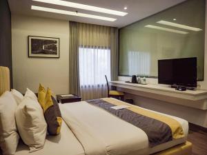 a hotel room with a bed and a television at Hotel Icon in Chandīgarh