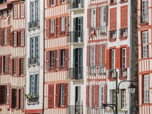 a tall building with many windows and a street light at Hôtel Mercure Bayonne Centre Le Grand Hotel in Bayonne