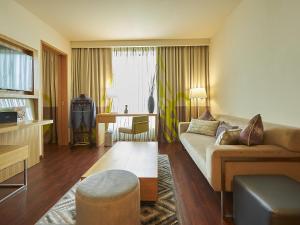 a living room with a couch and a table at Novotel Chennai OMR in Chennai