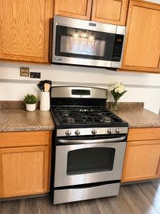 a kitchen with a stove and a microwave at The sunflower stay in Garden City +7 photos