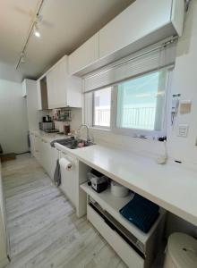 a kitchen with a white counter and a window at Ernie MyeongDon'g Sation 1Min, Anytime Check In in Seoul