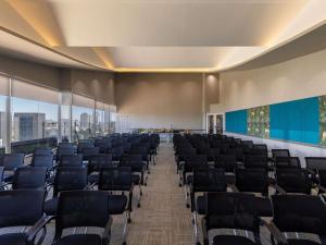 an empty conference room with chairs and large windows at ibis Styles - Nairobi, Westlands in Nairobi