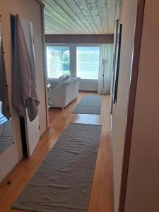 a living room with a couch and two rugs at Jänispolku in Rauma