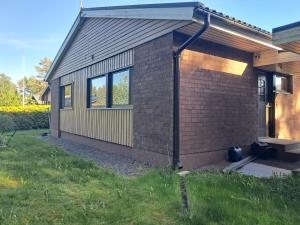 a small brick house with a pitched roof at Jänispolku in Rauma