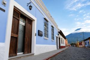 a street in a town with a mountain in the background at Casa Bella Boutique Hotel in Antigua Guatemala