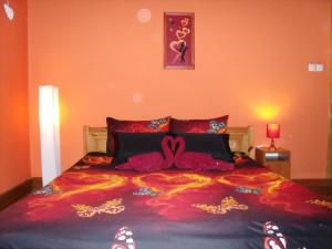 A bed or beds in a room at Viola Vendégház