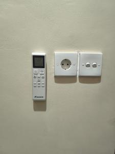 a remote control and an ipod on a wall at Batan Bingin House in Ubud