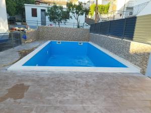 a swimming pool in the backyard of a house at Pool apartman Maja in Šibenik