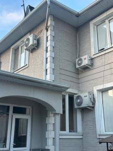 a house with two speakers on the side of it at Nomad Guest House Osh in Osh