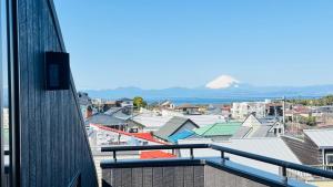 a view of a city from the balcony of a building at SANMI Hayama in Hayama