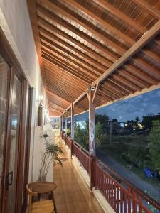 a porch with awning and a table and a stool at Sariuma babadan in Badung +8 photos