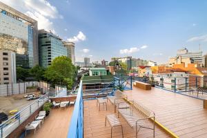 a balcony with chairs and a view of a city at Soosong Guesthouse Gwanghwamun Myeongdon g in Seoul