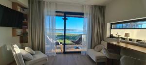 a living room with a large window with a view at Seaside Getaway Apartment in Haapsalu