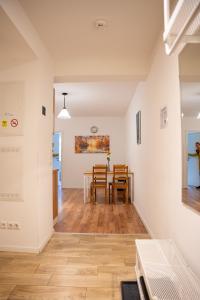 a dining room and kitchen with a table and chairs at OMNI - Homes - Waldstraße in Falkensee +11 photos
