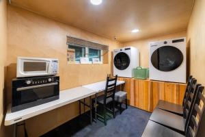 a kitchen with a counter with a microwave and a stove at Soosong Guesthouse Gwanghwamun Myeongdon g in Seoul