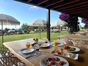 a wooden table with plates of food on it at Can Skye in Sant Carles de Peralta