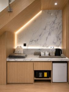 a kitchen with a sink and a counter top at Busan Seomyeon Nestly Hotel in Busan