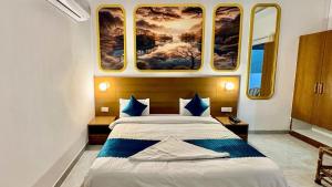 a bedroom with a bed with a painting on the wall at Boho Stays Rishikesh in Rishīkesh