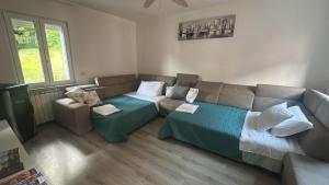 a living room with a bed and a couch at La Casa di Erika in Monasterolo del Castello