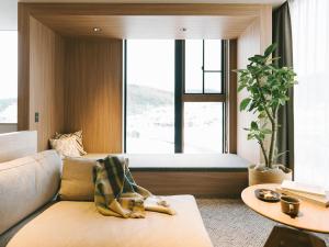 a living room with a couch and a large window at HOTEL & KOTEI SOKA in Kyotango +108 photos